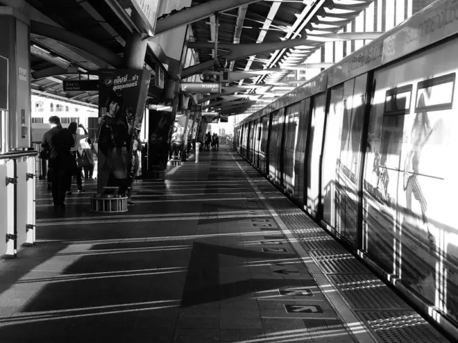 Commuters waiting on a BTS Skytrain platform in Bangkok