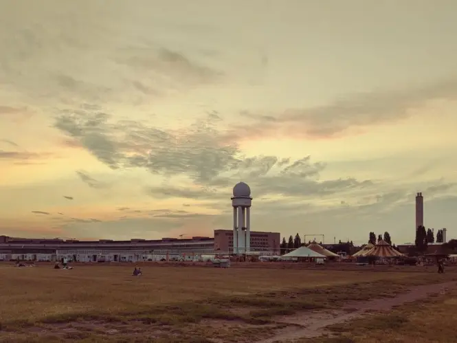 People cycling and relaxing on the open runways of the former Tempelhof Airport.