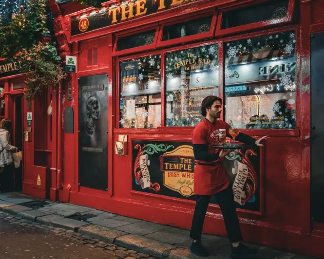 A traditional red brick pub facade in the Temple Bar district of Dublin.