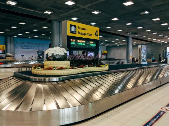 Suitcases on a baggage carousel at an airport terminal