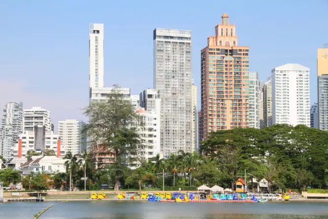 Lumphini Park lake with Bangkok skyline in the background