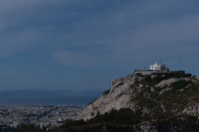 The white chapel of St. George on top of Mount Lycabettus overlooking the city of Athens