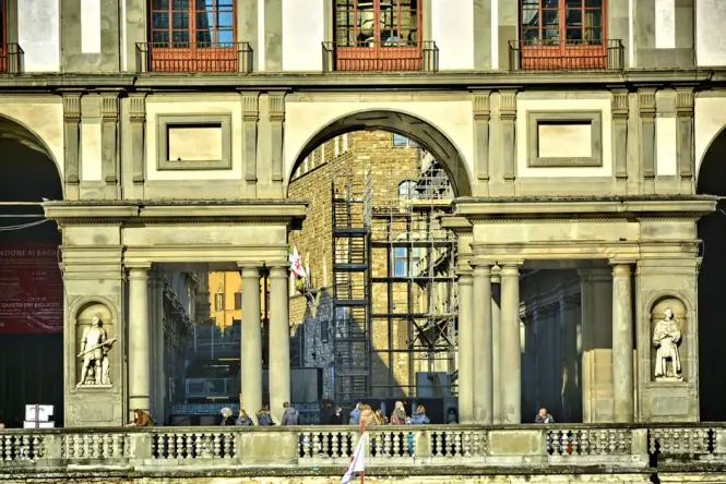 Crowds of people waiting outside a historic building in Florence