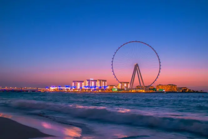 Sunset view of Ain Dubai with Palm Jumeirah in the distance