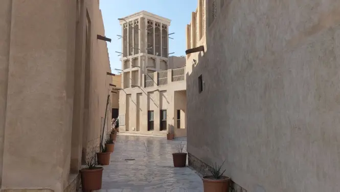 A narrow alleyway between gypsum walls in Al Fahidi Historical District