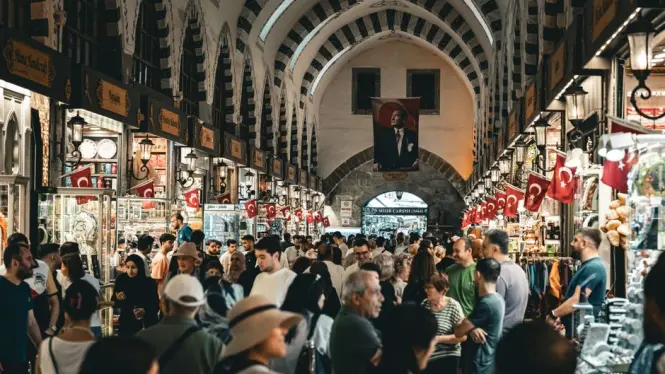 Shoppers walking between stalls at Albert Cuyp Market on a weekday morning