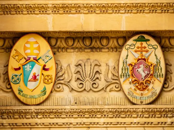 Heraldic coats of arms covering the walls of the Archiginnasio courtyard