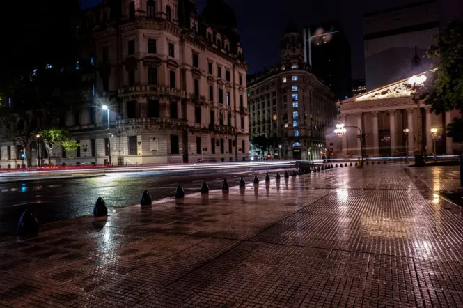 Avenida de Mayo lit up in the evening with pedestrians walking