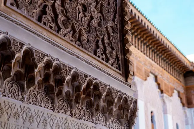 Close-up of the carved horseshoe arch and inscription bands on Bab Agnaou