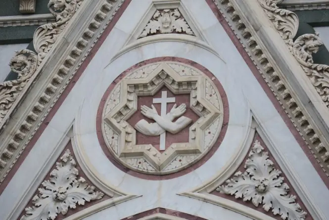 The ornate marble tomb of Michelangelo inside the Basilica of Santa Croce