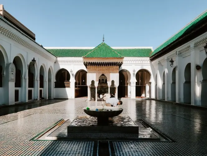 Empty tiled courtyard in early morning light at a Moroccan madrasa