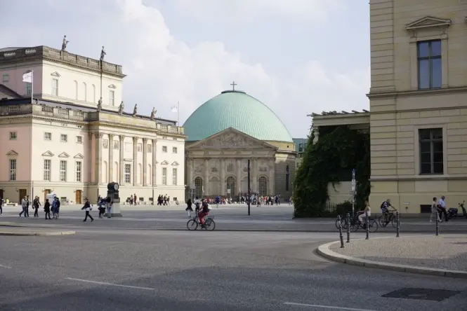 Quiet early morning view of Berlin Cathedral with few visitors in Lustgarten