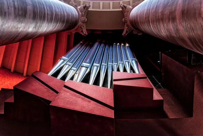 Candlelit organ concert setting inside a grand European cathedral nave