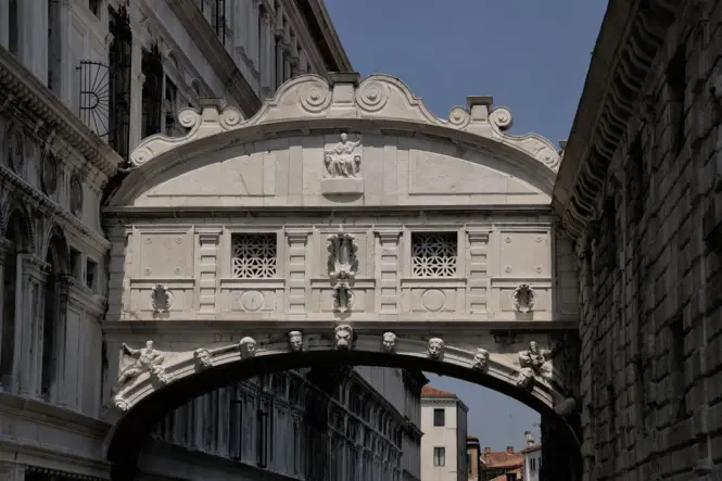 Pedestrians on Ponte della Paglia viewing the Bridge of Sighs