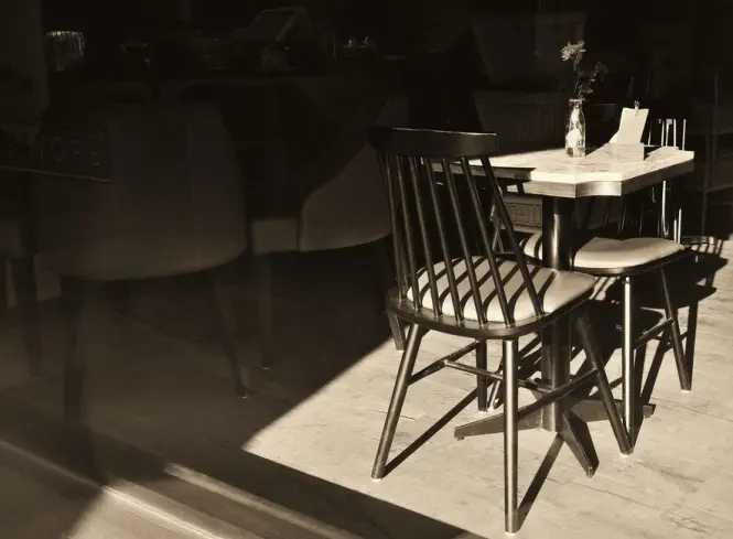 Quiet café interior in early morning light before crowds arrive