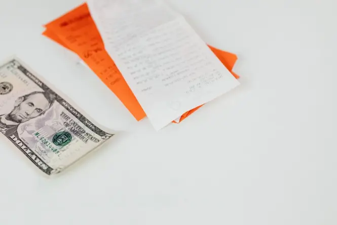Restaurant bill and euro cash on a café table
