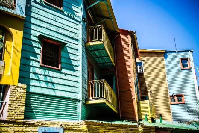 Sculpted figures and colorful balconies on a conventillo building along Caminito