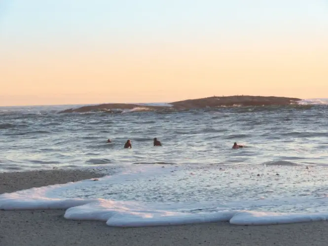 Swimmers entering the cold Atlantic water at Camps Bay Beach