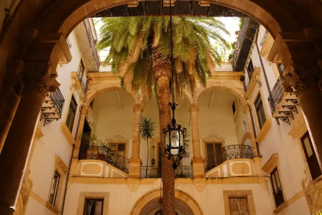 The quiet courtyard and entrance gates of the Capuchin Monastery in Palermo