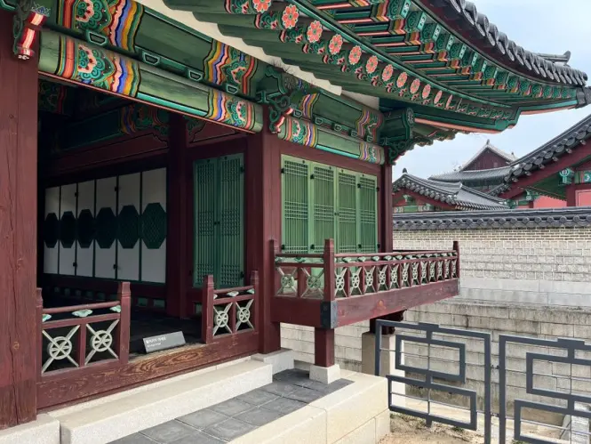 Ornate throne room interior with dragon ceiling at Injeongjeon Hall