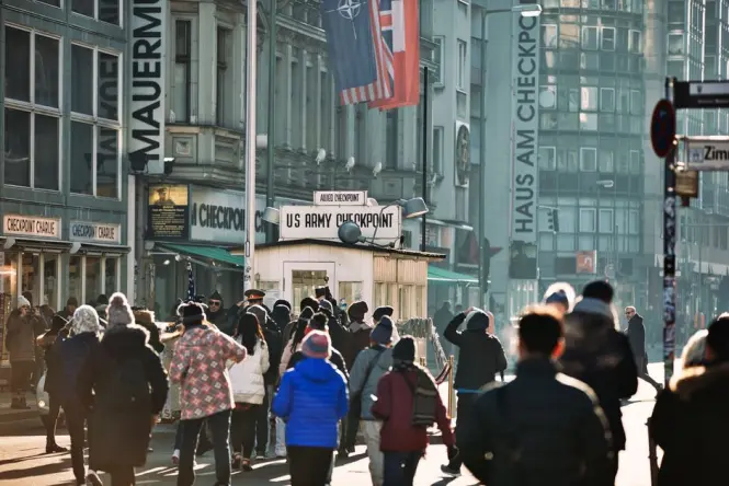 Costumed guard standing near the replica hut at Checkpoint Charlie