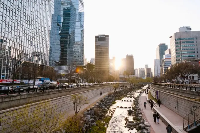 Stepping stones and bridge lights along Cheonggyecheon Stream after sunset