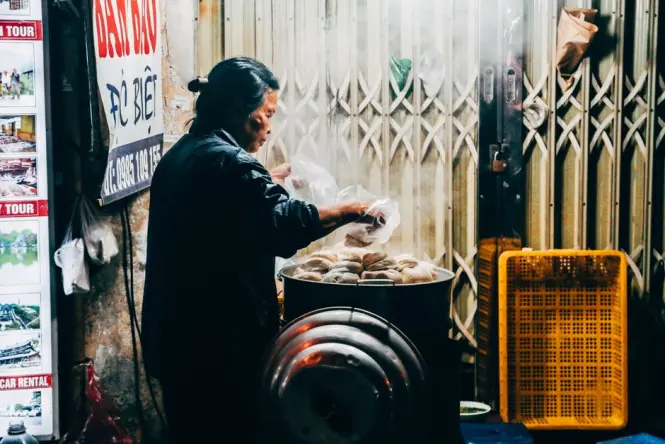 Street food vendors near Dong Xuan Market at night