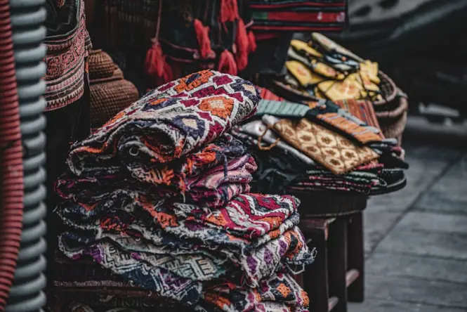 Rolls of fabric for sale on the ground floor of Dong Xuan Market