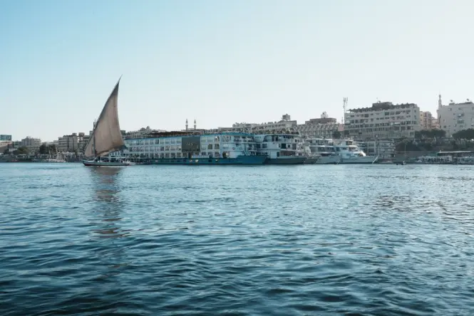 Illuminated traditional dhow used for dinner cruises on Dubai Creek