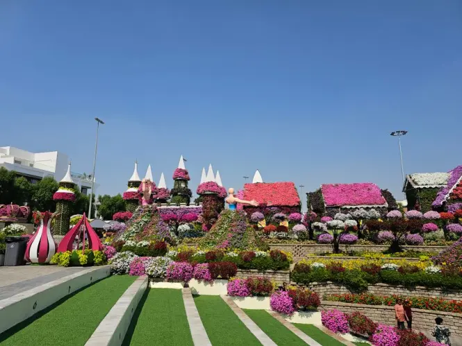Umbrella-covered walkway with flower beds at Dubai Miracle Garden