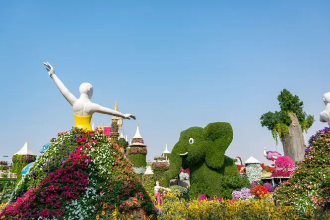 Visitors entering Dubai Miracle Garden through the main gate