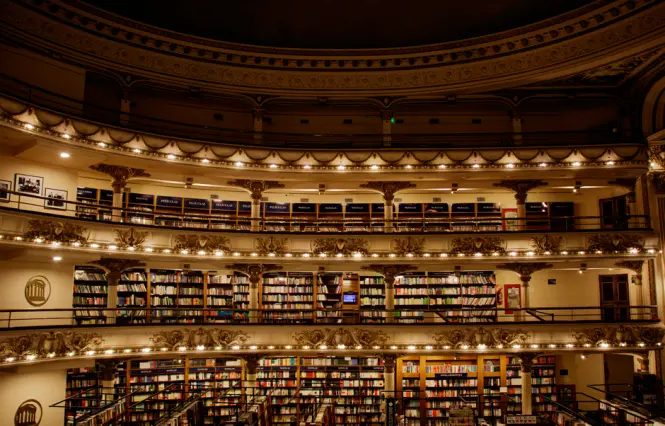 Evening view of Av. Santa Fe outside El Ateneo Grand Splendid with lit windows