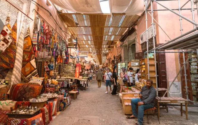 Quiet early morning alley inside a Marrakech covered souk before crowds arrive