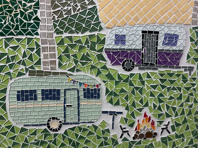 Close-up of a ceramic portrait tile among Jorge Selarón's mosaic work