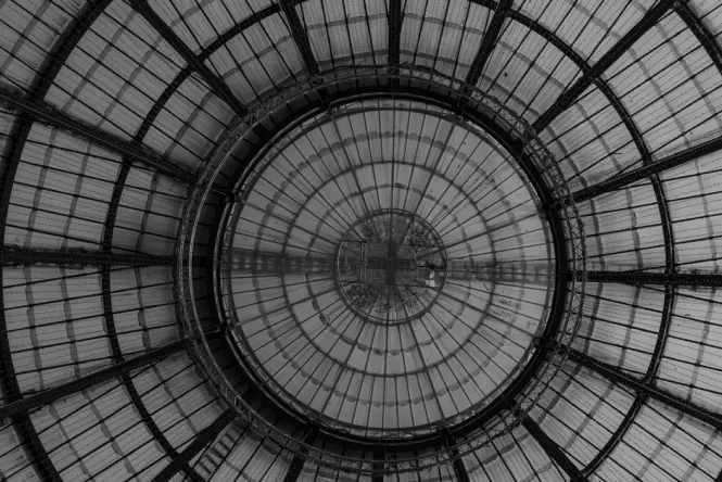 Detailed architectural view looking up at the glass and iron vaulting of the Galleria