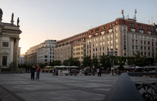 Quiet early morning light over Gendarmenmarkt square with few visitors