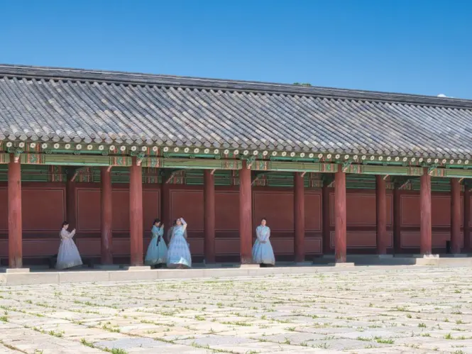 Colorful hanbok dresses displayed in a Gwangjang Market shop