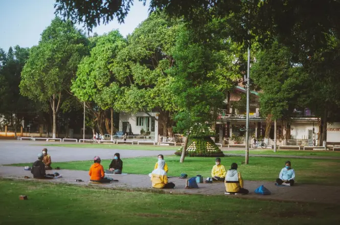 Local residents doing morning stretching exercises in the park