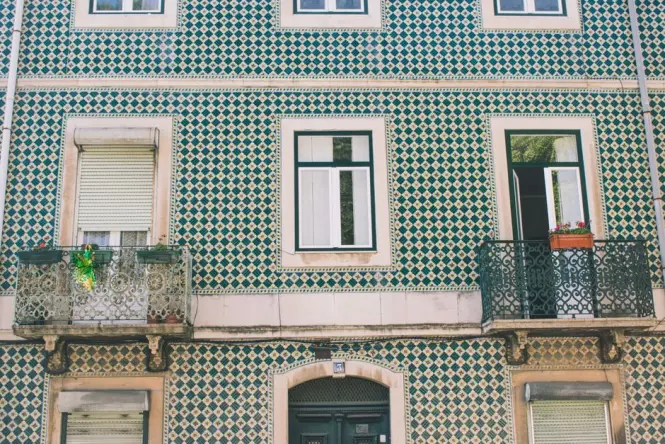 Close-up of uneven ceramic tiled windows on Hundertwasser House