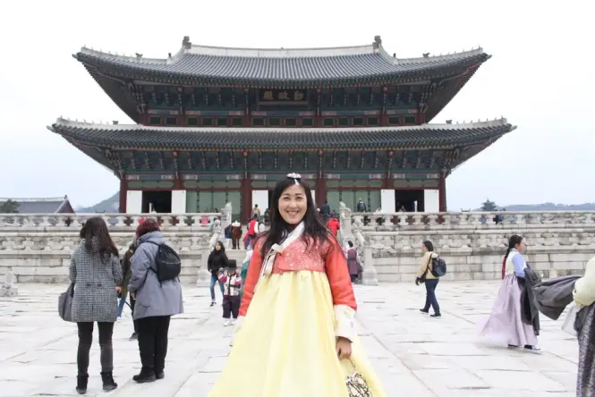 Visitor wearing rented hanbok walking through Ikseon-dong alley