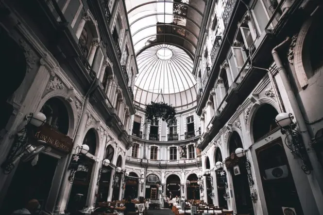Tables set for dinner inside the glass-roofed Cicek Pasaji flower passage off Istiklal Avenue