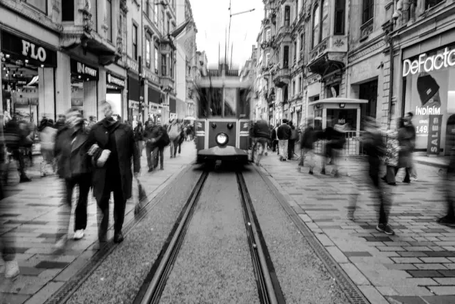 The nostalgic tram passing near Galatasaray Lisesi gate on Istiklal Avenue