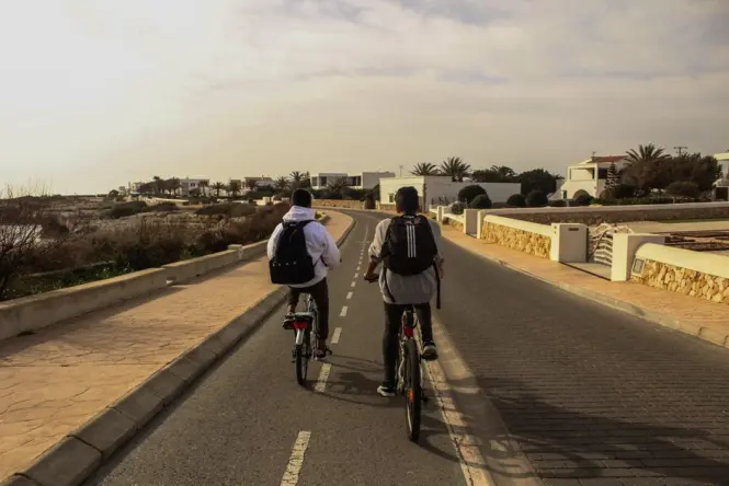 Cyclist riding the bike lane along La Corniche in Marseille