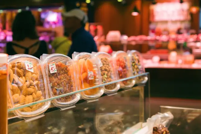 Colorful stalls filled with fresh fruits and juices inside La Boqueria market