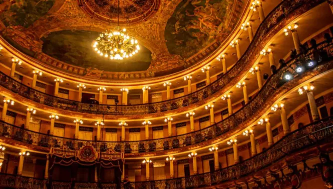 Historical musical instruments and portraits inside the La Scala Museum in Milan