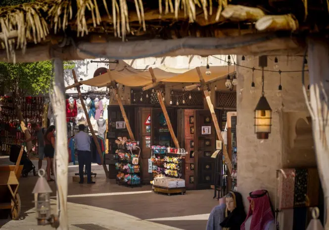 Shoppers browsing lantern-lit stalls inside the Madinat Jumeirah souk