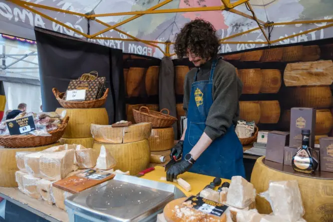 Wheels of cheese displayed at a market stall