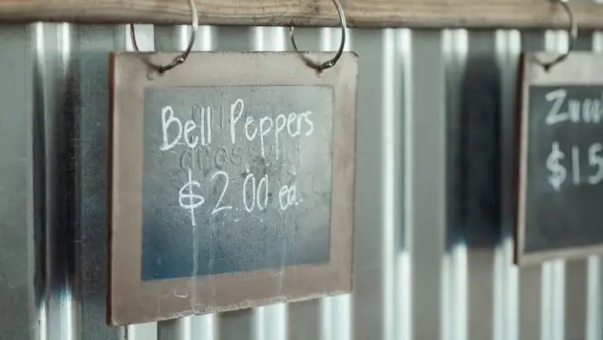 Hawker stall menu board showing dish prices in Singapore dollars
