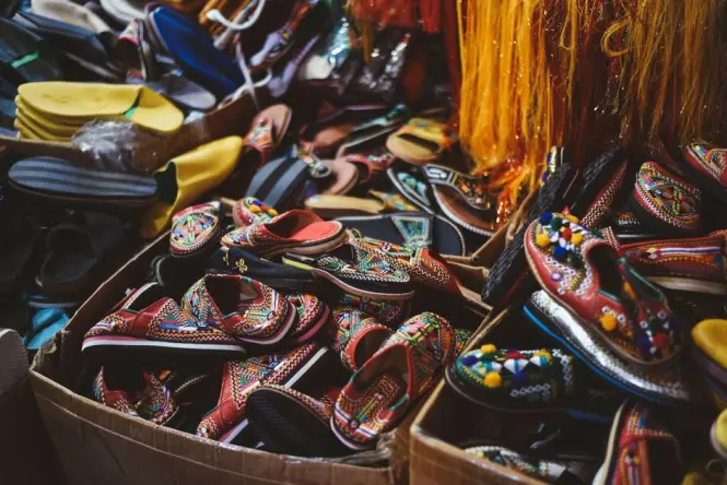 Colorful leather slippers displayed in a Marrakech souk stall