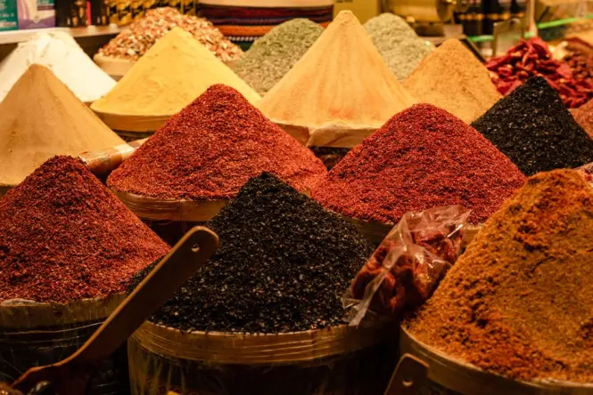 Piles of saffron and paprika spices displayed in the Mellah souk of Marrakech